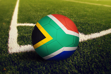 South Africa ball on corner kick position, soccer field background. National football theme on...