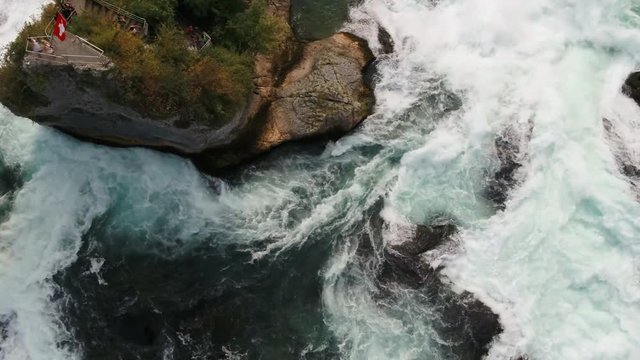 Europe's largest waterfall - Rhine Falls. By ship u can reach castles, the Falls Basin and even the rock in of the waterfall.
Top down drone view to the waterflow and the rock in the middle.