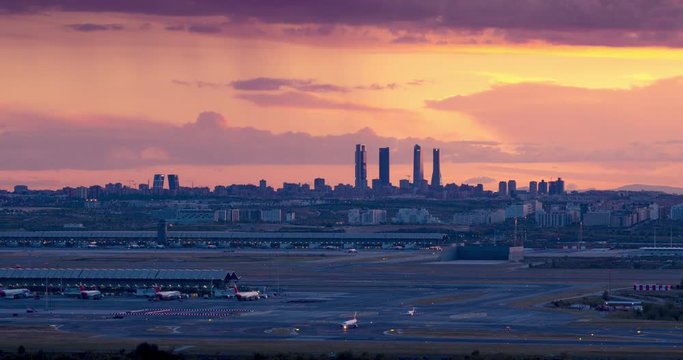 Sunset seen from Paracuellos del Jarama. Timelapse of Madrid skyline with beautiful sunset and impressive storm clouds. Madrid airport and 4 towers bussines area as main subject.