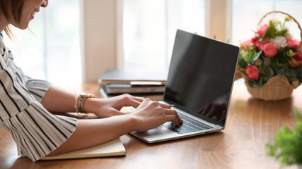 Woman hand on keyboard of laptop while working in home office