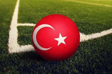 Turkey ball on corner kick position, soccer field background. National football theme on green...