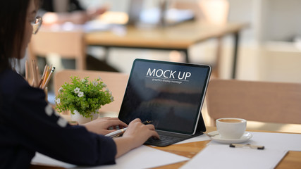 Businesswoman using tablet with in office