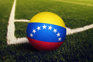 Venezuela ball on corner kick position, soccer field background. National football theme on green grass.