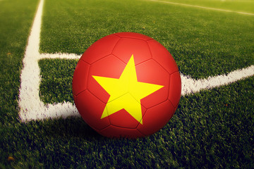 Vietnam ball on corner kick position, soccer field background. National football theme on green...
