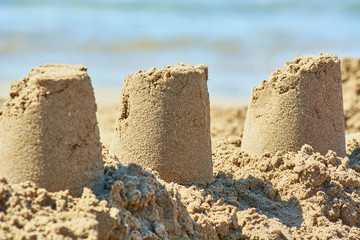 Sand castle made by childrens bucket on beach.