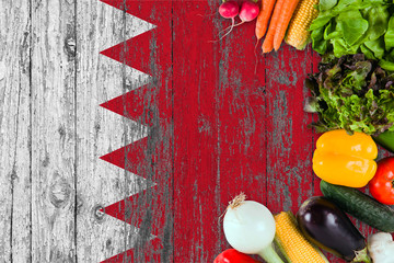 Fresh vegetables from Bahrain on table. Cooking concept on wooden flag background.