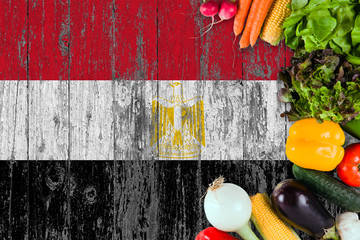 Fresh vegetables from Egypt on table. Cooking concept on wooden flag background.