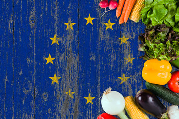 Fototapeta premium Fresh vegetables from European Union on table. Cooking concept on wooden flag background.