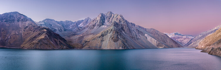 Embalse del Yeso (Yeso Dam) awe high altitude turquoise waters lake inside an amazing rugged landscape. Steep mountains on an awe scenery with the river stopped by the dam inside Andes mountains - obrazy, fototapety, plakaty