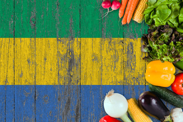 Fresh vegetables from Gabon on table. Cooking concept on wooden flag background.