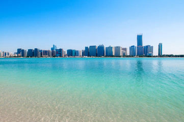 Obraz premium Blue sea at marina island with modern Abu Dhabi skyline cityscape