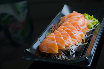 Salmon Sashimi on Black Ceramic Plat,black background.
