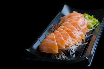 Salmon Sashimi on Black Ceramic Plat,black background.