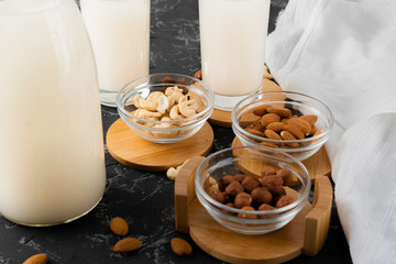 assorted nuts such as almond, cashew, hazelnut and milk in a glass bottle, healthy foods