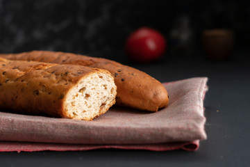 fresh tasty bread or baguette on black surface at the kitchens