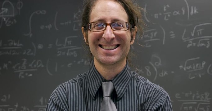 Happy smiling professor, scientist, or math genius looking at the camera