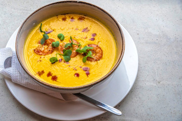 Tom yum soup with three shrimps on top
