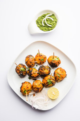 Tandoori aloo are roasted potatoes with Indian spices. It's a party appetiser served with green chutney. selective focus