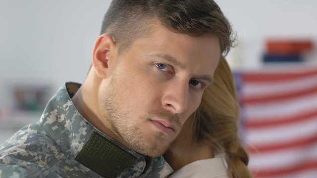 Sad military husband hugging girlfriend, looking in camera closeup, farewell