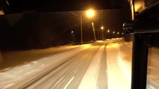 Bus passenger point of view of a bus driving on a icy road in the polar arctic circle in Lapland, Finland