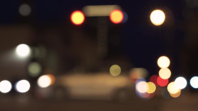 Out of focus traffic, in the city, at night.