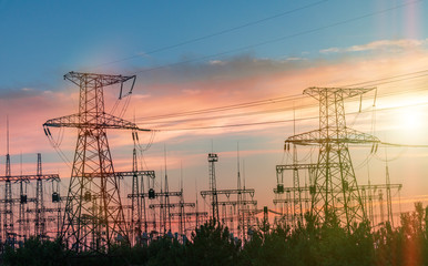 Electricity pylons and power lines, at sunset.