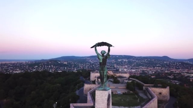 Aerial footage by the liberty statue of Budapest, Hungary, with a general view the city during early morning light.