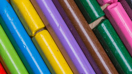Colourful used crayons in a diagonal row