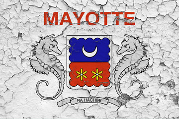 Flag of Mayotte painted on cracked dirty wall. National pattern on vintage style surface.