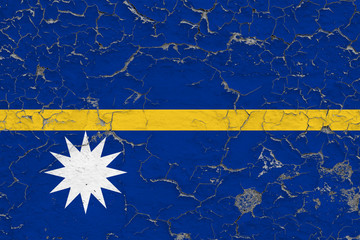 Flag of Nauru painted on cracked dirty wall. National pattern on vintage style surface.