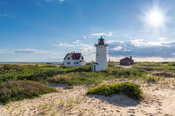 Fototapeta na wymiar Cape Cod beach, Race Point lighthouse at Sunset, Massachusetts, USA.