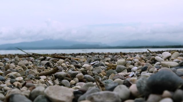 Garda lake Italy pebbels beach slight movement of water in the background - Family summer vacation
