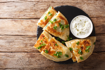 Bolani flat-bread from Afghanistan, baked or fried with a vegetable filling and served with plain yogurt closeup. Horizontal top view