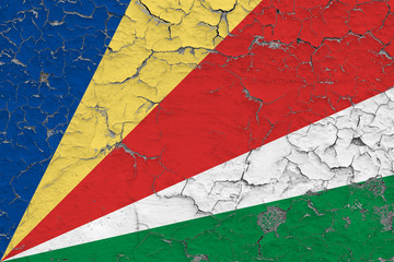 Flag of Seychelles painted on cracked dirty wall. National pattern on vintage style surface.