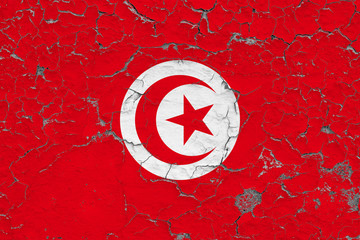 Flag of Tunisia painted on cracked dirty wall. National pattern on vintage style surface.