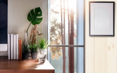 home office with desktop computer, books and houseplant.