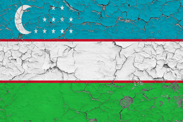 Flag of Uzbekistan painted on cracked dirty wall. National pattern on vintage style surface.