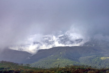Fototapeta na wymiar Clouds and fog over mountains