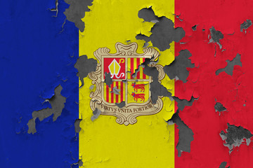 Close up grungy, damaged and weathered Andorra flag on wall peeling off paint to see inside surface.