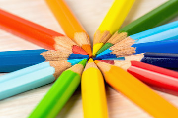 Color pencils in a circle on a white background. Drawing with colored pencils.