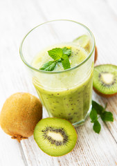 Glass of kiwi smoothie with fresh fruits