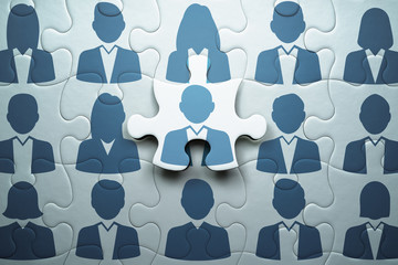 Selecting person and building team. Human resource management and teamwork concept.Connecting last jigsaw puzzle piece. - Powered by Adobe