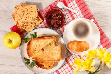 Toasted slices of bread with cheese, apple, cookies and cup of coffee.