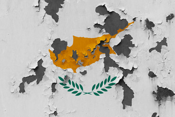 Close up grungy, damaged and weathered Cyprus flag on wall peeling off paint to see inside surface.