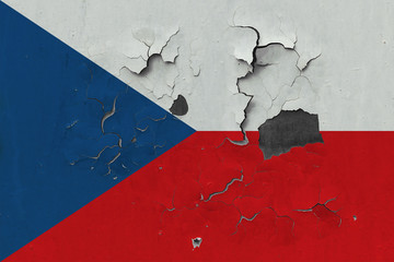 Close up grungy, damaged and weathered Czech Republic flag on wall peeling off paint to see inside surface.