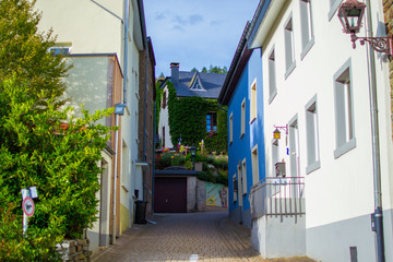 Narrow street in middle of Clervaux, in Luxembourg, with typical houses at both sides