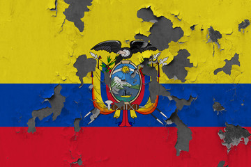 Close up grungy, damaged and weathered Ecuador flag on wall peeling off paint to see inside surface.