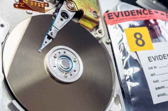 Hard disk opened in criminological laboratory, conceptual image