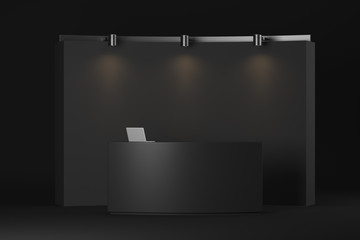 Office reception desk with laptop. Black empty wall behind with bright lights above the wall. Mock up. 3d rendering