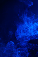 Blue smoke on black background.